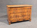 an antique chest of drawers with a wooden top on a grey background