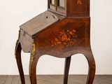 a small wooden desk with a mirror on top of it