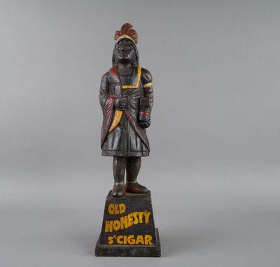 an old wooden statue of a man with a hat on his head