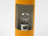an orange lamp with a light bulb sitting on top of it