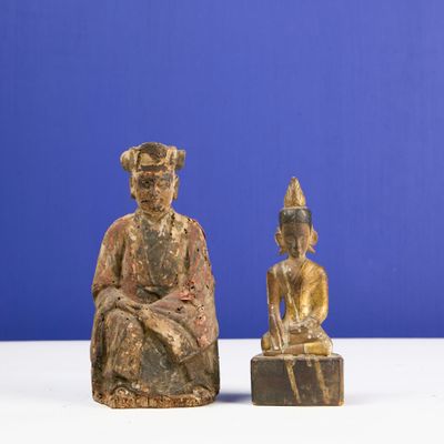 pair of carved wooden figures of a seated man and a seated woman