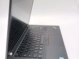a laptop with a black keyboard on a white surface