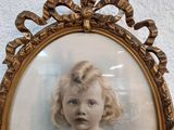 a picture of a little girl that is in a picture frame
