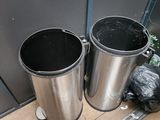 two trash cans sitting next to each other on the floor