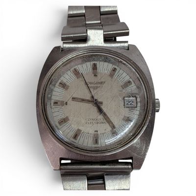 a silver wrist watch with roman numerals on it
