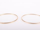 a pair of gold rings on a white background