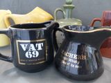 two coffee mugs sitting next to each other on a table