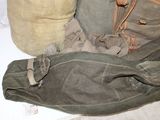 a bag and a pair of pants sitting on the floor