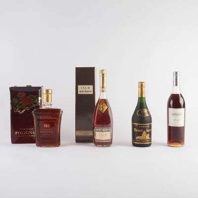 trois bouteilles d'alcool sont alignées sur une surface blanche