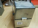 a small metal box sitting on a table in a room
