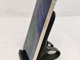 a cell phone that is on a stand on the table