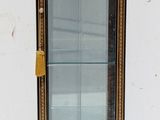 a small display case with a glass door in it