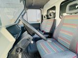 the interior of a van with two seats and a steering wheel