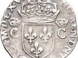 a close up of a silver coin with a crown on it