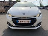 the front view of a white car parked in a parking lot