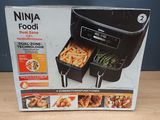 packaging of the ninja foodi dual zone is shown on a table