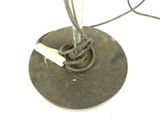a metal object with a cigarette in it on a white surface