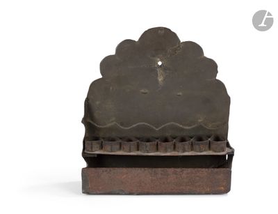 a small metal object that is sitting on a white surface