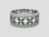 a white gold ring with green and white diamonds