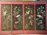 four panels with birds and flowers on them on display