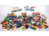 a pile of toy cars and trucks on a white surface