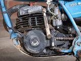 a close up of a blue motorcycle parked in a garage