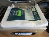 a bag of toilet paper sitting on top of a machine