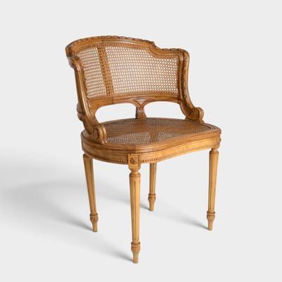 an image of a wooden chair with a cane back and a cane seat