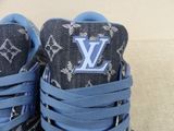 louis vuitti sneakers with blue laces and a monogram print on them