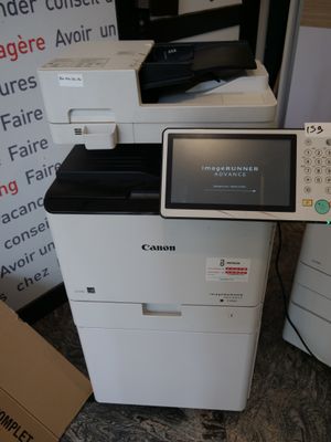 a white printer sitting on top of a pile of boxes