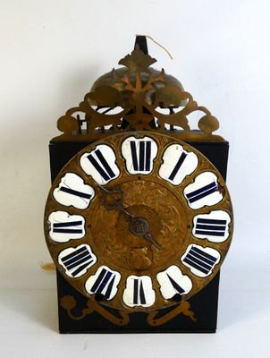 a black and gold clock with white numbers on it