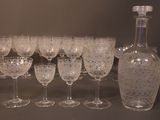 many wine glasses and a bottle of wine on a table