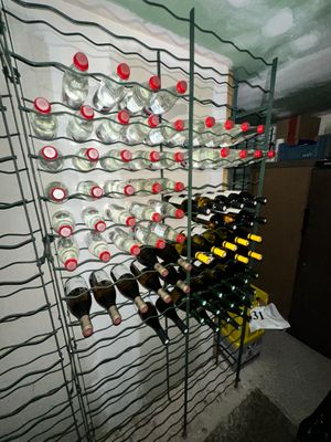 many bottles of wine in a wine rack in a room