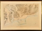 an old map of a city in a frame on a wall