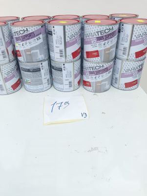 several cans of paint sitting on top of a table next to a sign