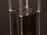 a close up of a metal object on a black surface