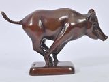 bronze statue of a bull on a wooden base on a white background