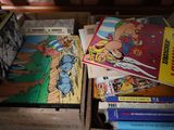 many comics in a wooden box on a table