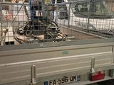 un camion équipé d'une cage à l'arrière, à l'intérieur d'un bâtiment