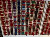 a large display of different colored ribbons on the wall