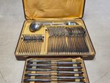 a lot of silverware in a case on a table