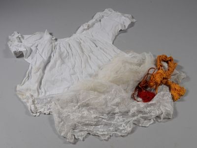 un ours en peluche et une robe blanche posés sur une table