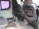 two seats in the back of a van that has been vandalized