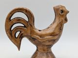 wooden sculpture of a rooster on a pedestal on a white background
