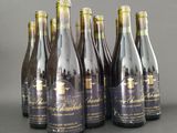 six bottles of wine are lined up in a row on a table