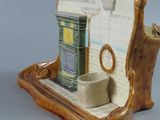 a ceramic figurine of a bathroom with a toilet and sink