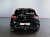the rear end of a black car in a white room