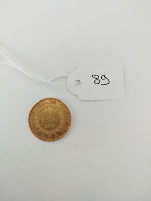 a close up of a gold coin on a white surface