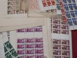 a lot of stamps on a table with a pen