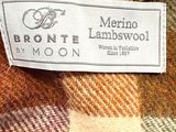 the label of a brown and tan plaid jacket is on the label of a brown and tan plaid jacket